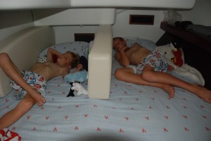 The boys sleeping with their "wall" to give them their own little area.