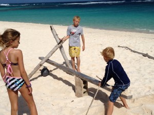 Building some structure with driftwood, rope, and lobster bouys.