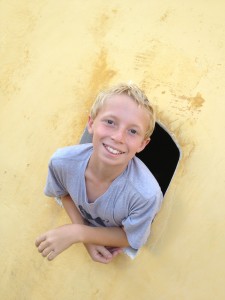 Bryson peeks out of a tiny window in the fort.