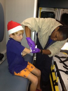 Porter visits the first aid truck after falling and scraping his arm on the sidewalk.