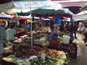 the colorful produce market.  all the ladies wear traditional madras dresses in bright green, orange,and red