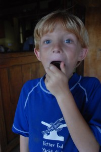 The ever-more-adventurous Porter tries a new fruit, picked off the tree at the village.