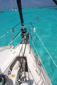 The anchor locker is open to show the windlass.  Chris swims out to our anchor bouy, which floats directly above our anchor.