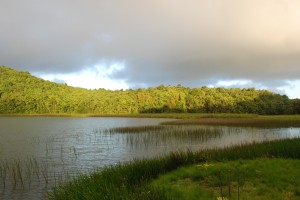 The crater left by the volcano has created a serene lake.