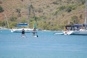 The guys spy on Lana and I paddleboarding back to our boats after lounging on the beach.  I totally fell off mine right after this!