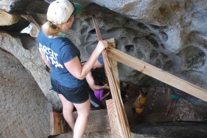 Lana and the rest of the crew negotiate the steep steps into the cavern.