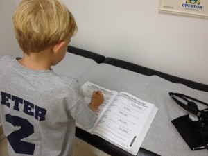 Porter does his schoolwork while we wait for the doctor.