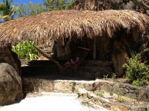 Reese reads on a hammock in the shade.