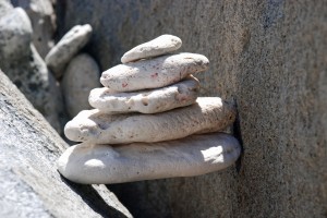 We all make cairns on a quiet, ocean side beach.